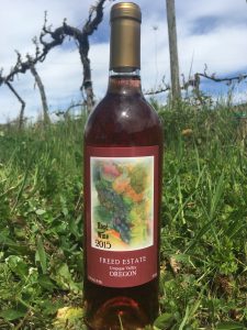 Freed Estate Winery bottle of Rose in the vineyard.